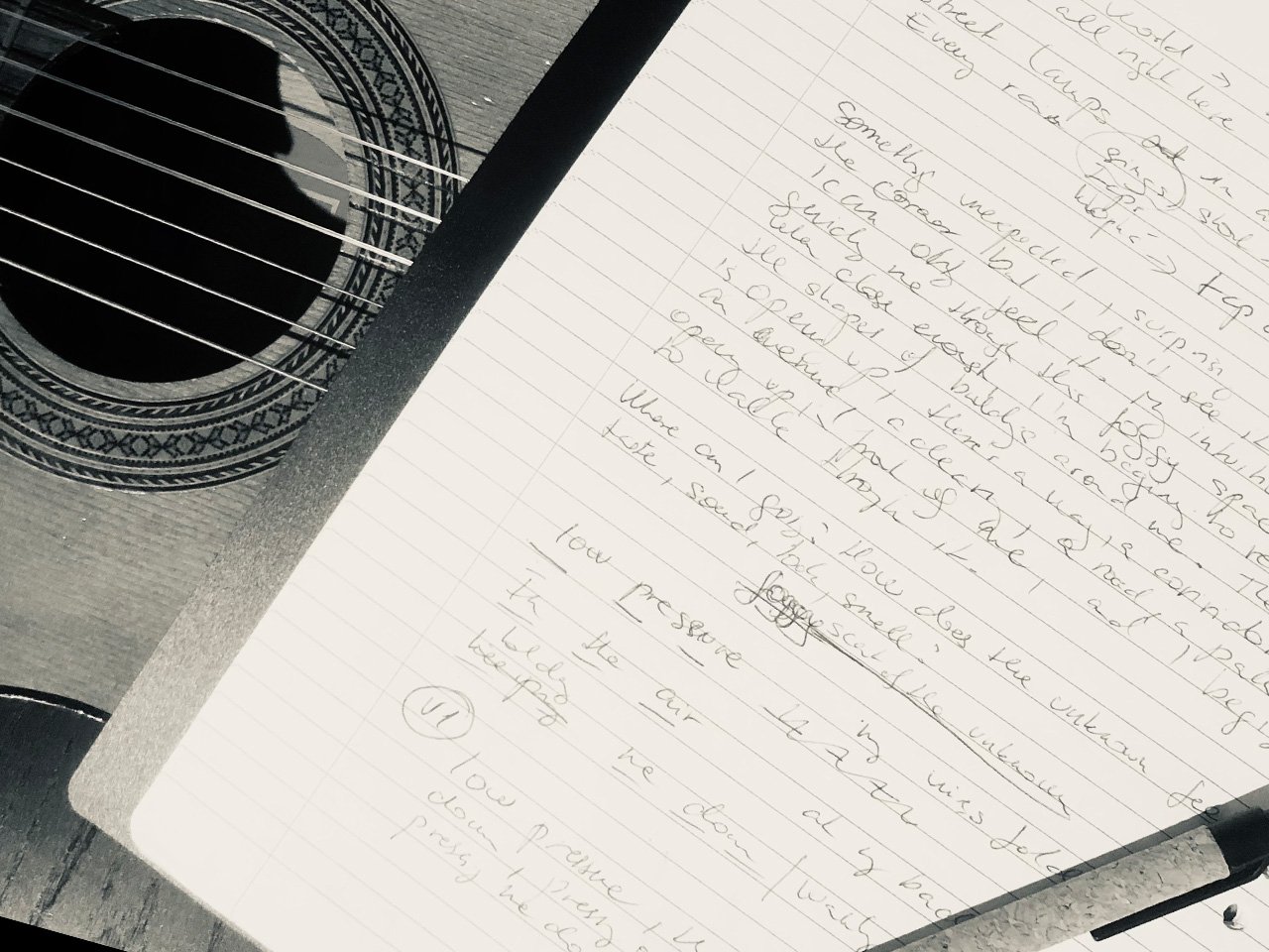 Handwritten song lyrics in a notebook